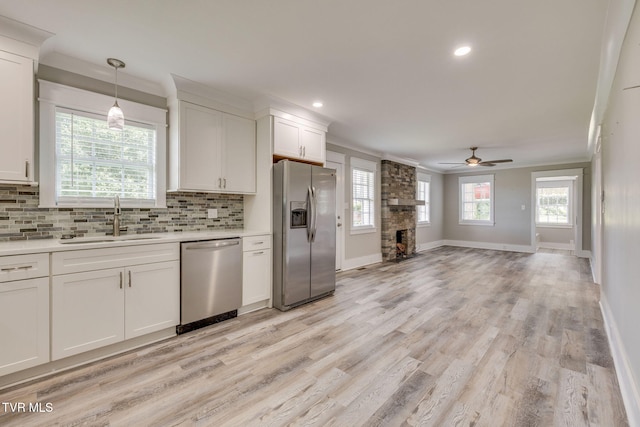 3528 Crestwood Dr, Kingsport, TN 37664 - kitchen with appliances with stainless steel finishes, crown molding, a ceiling fan, decorative backsplash, and light countertops
