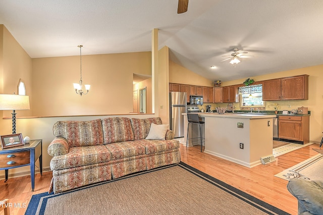 103 Jenny Ln, Jonesborough, TN 37659 - living area with a ceiling fan, light wood finished floors, vaulted ceiling, and a chandelier