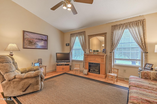 103 Jenny Ln, Jonesborough, TN 37659 - living area with light wood-type flooring, ceiling fan, lofted ceiling, and a glass covered fireplace