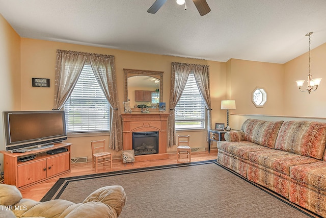 103 Jenny Ln, Jonesborough, TN 37659 - living room featuring healthy amount of natural light, a ceiling fan, a chandelier, and a glass covered fireplace