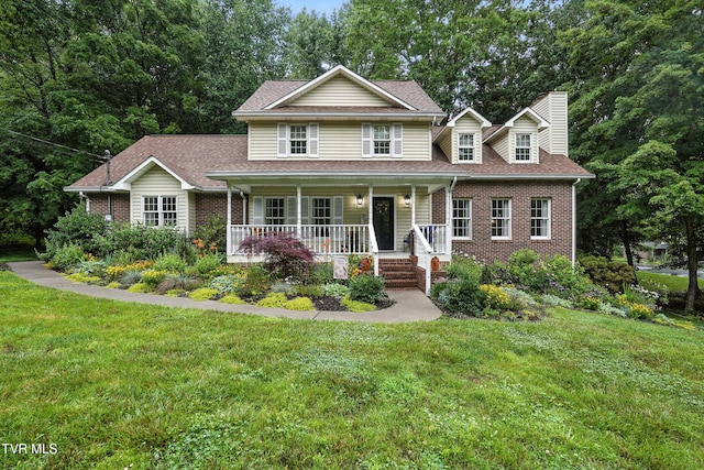 209 Timberland Cir, Kingsport, TN 37664 - view of front of house featuring brick siding, a porch, a chimney, and a front lawn