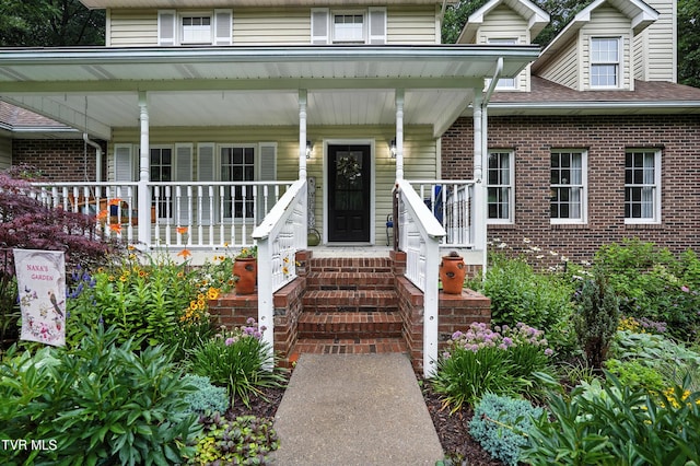 209 Timberland Cir, Kingsport, TN 37664 - doorway to property with brick siding, covered porch, and a shingled roof