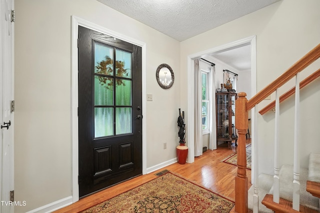 209 Timberland Cir, Kingsport, TN 37664 - foyer entrance featuring wood finished floors, stairs, and a textured ceiling
