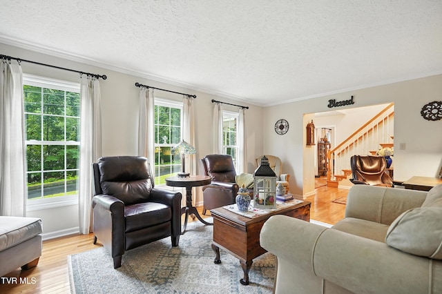 209 Timberland Cir, Kingsport, TN 37664 - living area featuring stairs, a textured ceiling, light wood-style floors, and crown molding