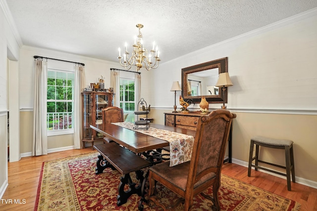 209 Timberland Cir, Kingsport, TN 37664 - dining room featuring a chandelier, wood finished floors, a textured ceiling, and crown molding