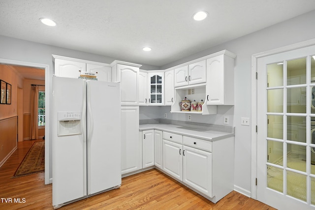 209 Timberland Cir, Kingsport, TN 37664 - kitchen featuring white fridge with ice dispenser, light wood-style floors, white cabinetry, glass insert cabinets, and light countertops