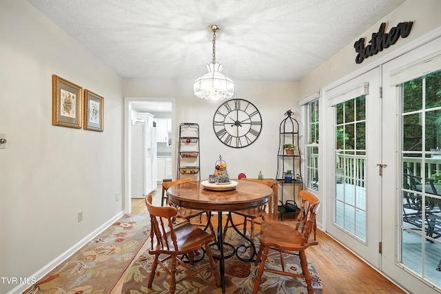 209 Timberland Cir, Kingsport, TN 37664 - dining space with a chandelier, light wood-style flooring, and a textured ceiling
