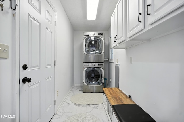 209 Timberland Cir, Kingsport, TN 37664 - laundry area with light marble finish flooring, stacked washer and clothes dryer, and cabinet space