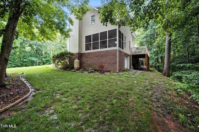 209 Timberland Cir, Kingsport, TN 37664 - rear view of house with brick siding, a garage, a sunroom, a lawn, and a wooden deck
