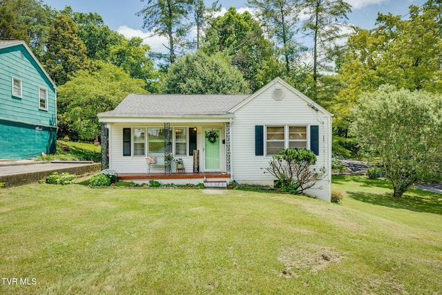 49 24th St, Bristol, TN 37620 - view of front facade featuring covered porch, a front lawn, and view of scattered trees