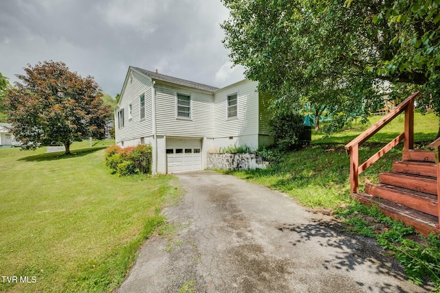 49 24th St, Bristol, TN 37620 - view of property exterior with asphalt driveway, a garage, and a lawn