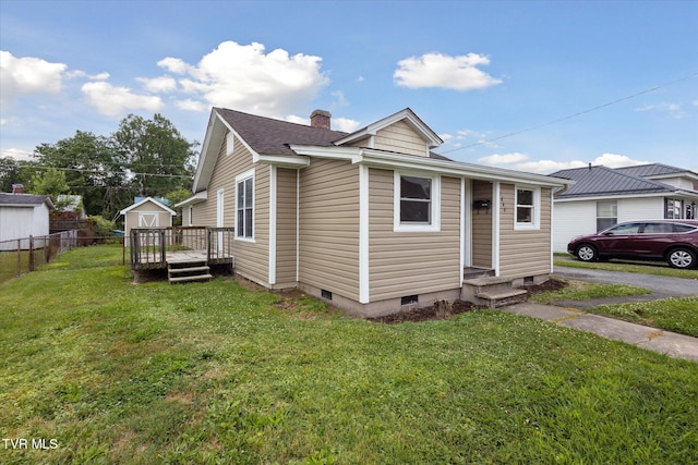 1449 E Sevier Ave, Kingsport, TN 37664 - view of home's exterior featuring a wooden deck, a chimney, and roof with shingles
