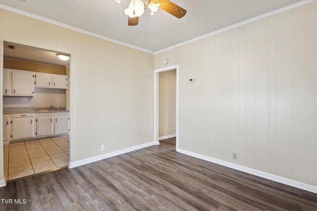1449 E Sevier Ave, Kingsport, TN 37664 - spare room featuring dark wood finished floors, ornamental molding, and ceiling fan