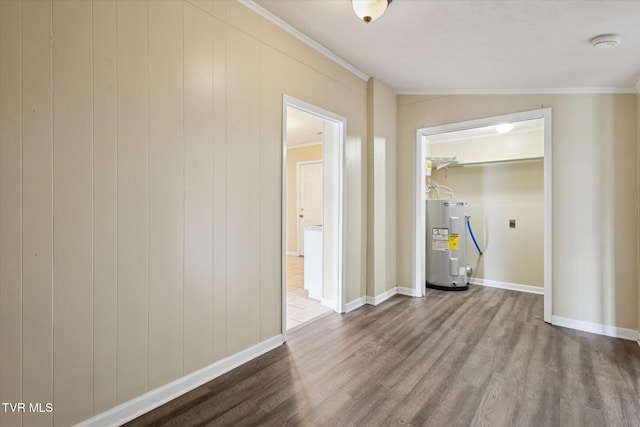 1449 E Sevier Ave, Kingsport, TN 37664 - empty room featuring water heater, wood finished floors, crown molding, and a smoke detector