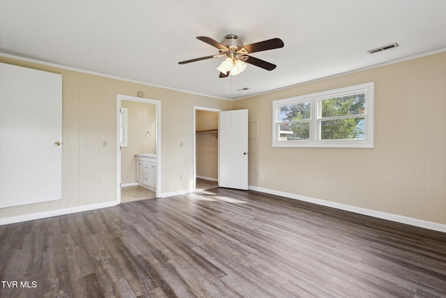 1449 E Sevier Ave, Kingsport, TN 37664 - unfurnished bedroom featuring wood finished floors, crown molding, a spacious closet, and ensuite bathroom