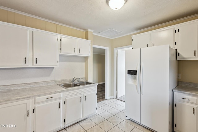 1449 E Sevier Ave, Kingsport, TN 37664 - kitchen featuring white refrigerator with ice dispenser, light countertops, light tile patterned floors, white cabinetry, and ornamental molding
