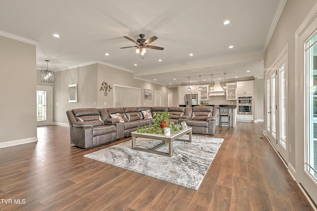 20385 Yeary Trl, Abingdon, VA 24211 - living room with dark wood finished floors, recessed lighting, ornamental molding, ceiling fan, and a chandelier