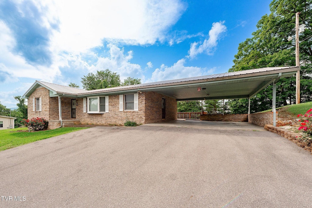 110 Richard Ln, Fall Branch, TN 37656 - view of front of property with asphalt driveway, a metal roof, brick siding, and a carport