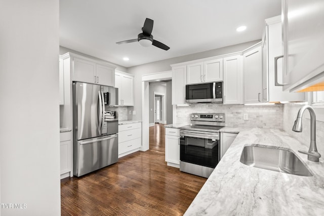 409 Pennsylvania Ave, Bristol, TN 37620 - kitchen with appliances with stainless steel finishes, a ceiling fan, white cabinetry, light stone counters, and decorative backsplash