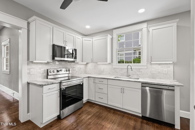 409 Pennsylvania Ave, Bristol, TN 37620 - kitchen with stainless steel appliances, white cabinetry, dark wood-type flooring, light stone countertops, and recessed lighting