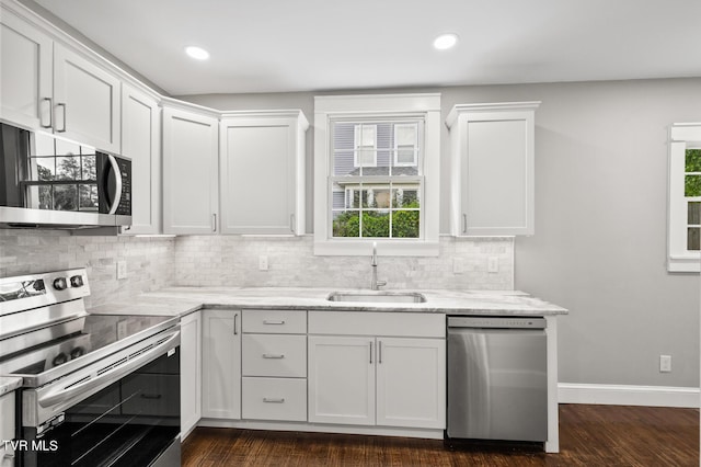 409 Pennsylvania Ave, Bristol, TN 37620 - kitchen with appliances with stainless steel finishes, healthy amount of natural light, decorative backsplash, white cabinetry, and recessed lighting