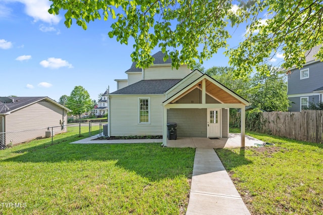 409 Pennsylvania Ave, Bristol, TN 37620 - rear view of property with a fenced backyard, a shingled roof, and a patio area