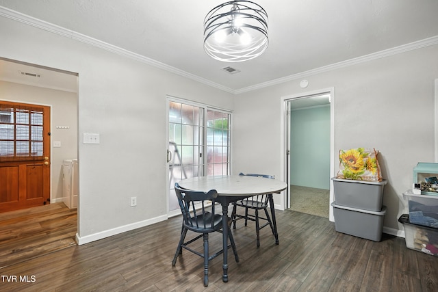 169 Mays Rd, Elizabethton, TN 37643 - dining room featuring dark wood-type flooring, ornamental molding, and washing machine and clothes dryer