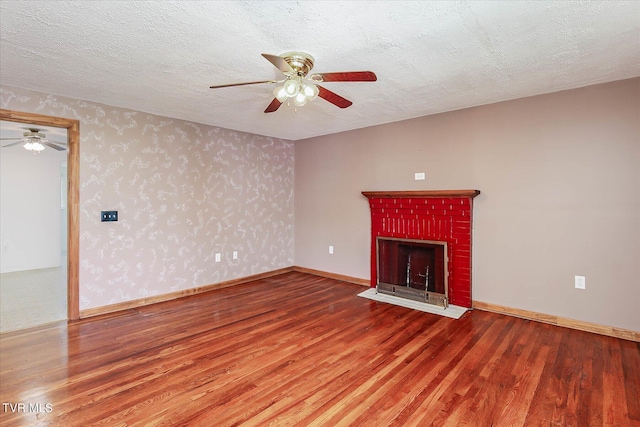 227 Jonesboro Dr, Bluff City, TN 37618 - unfurnished living room with ceiling fan, wood finished floors, a brick fireplace, and a textured ceiling