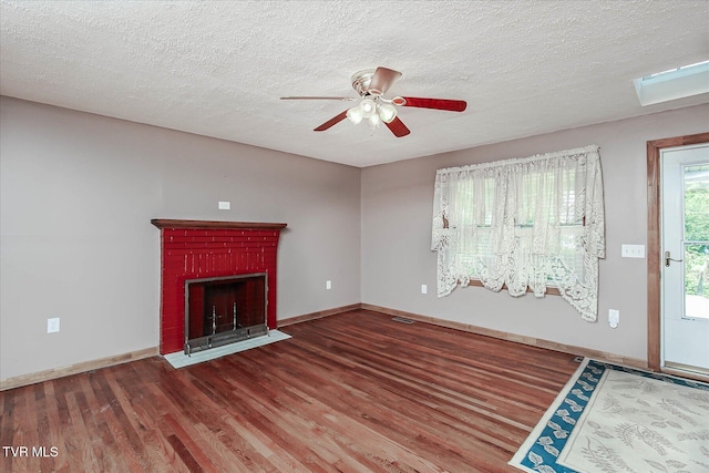 227 Jonesboro Dr, Bluff City, TN 37618 - unfurnished living room featuring wood finished floors, a ceiling fan, a brick fireplace, and a textured ceiling