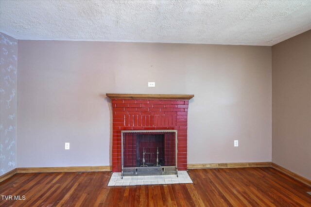 227 Jonesboro Dr, Bluff City, TN 37618 - detailed view of wood finished floors, a textured ceiling, and a fireplace with flush hearth