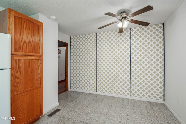 227 Jonesboro Dr, Bluff City, TN 37618 - spare room with ceiling fan, a smoke detector, wallpapered walls, light flooring, and a textured ceiling