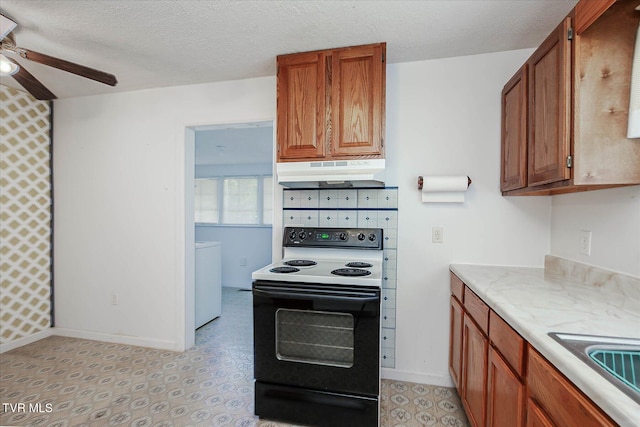227 Jonesboro Dr, Bluff City, TN 37618 - kitchen with range with electric cooktop, under cabinet range hood, a ceiling fan, light countertops, and brown cabinetry