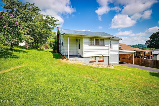 227 Jonesboro Dr, Bluff City, TN 37618 - back of property featuring asphalt driveway, a metal roof, a chimney, and a carport