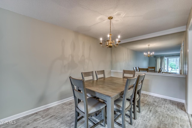 202 University Pkwy Unit 4E, Johnson City, TN 37604 - dining room featuring a chandelier, wood finished floors, a textured ceiling, and crown molding