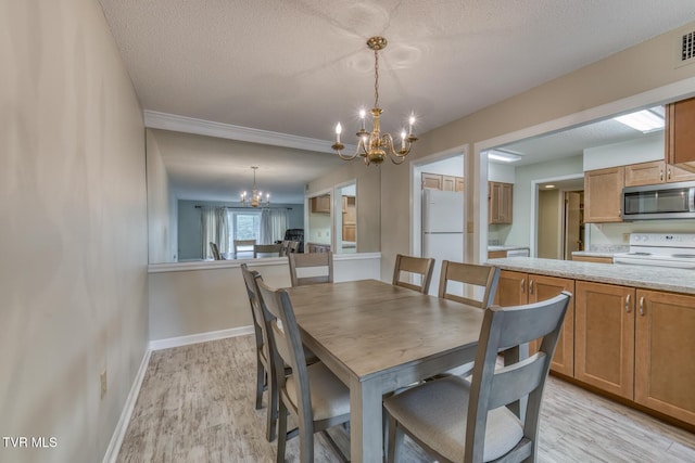 202 University Pkwy Unit 4E, Johnson City, TN 37604 - dining space with a chandelier, light wood-style floors, and a textured ceiling