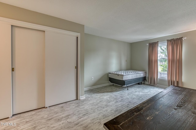 202 University Pkwy Unit 4E, Johnson City, TN 37604 - bedroom with wood finished floors, a closet, and a textured ceiling