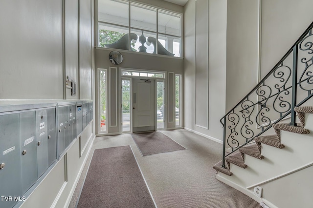 202 University Pkwy Unit 4E, Johnson City, TN 37604 - entrance foyer with a high ceiling, carpet, stairway, mail area, and a decorative wall
