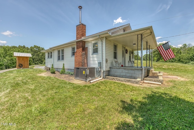 406 Mclaney Rd, Watauga, TN 37694 - rear view of house with a chimney, a yard, covered porch, and an outbuilding