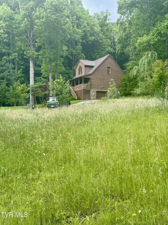 103 Meadow Springs Ct, Flag Pond, TN 37657 - view of yard featuring an attached garage and a wooded view