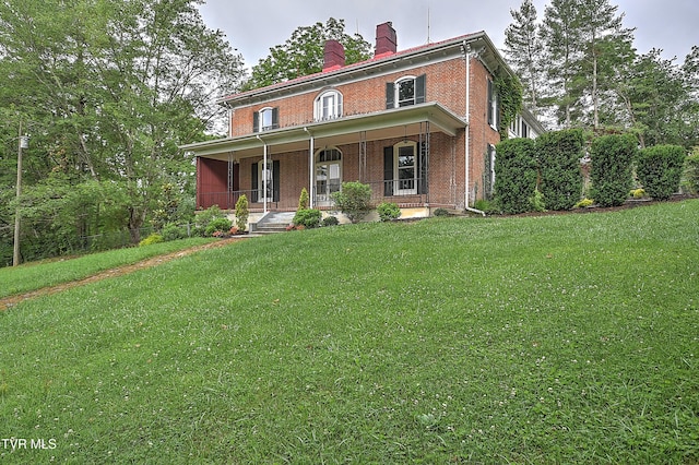 2061 King College Rd, Bristol, TN 37620 - italianate house with a porch, brick siding, a front lawn, and a chimney