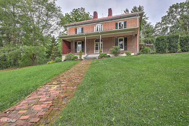 2061 King College Rd, Bristol, TN 37620 - italianate house featuring brick siding, covered porch, a front lawn, and a chimney