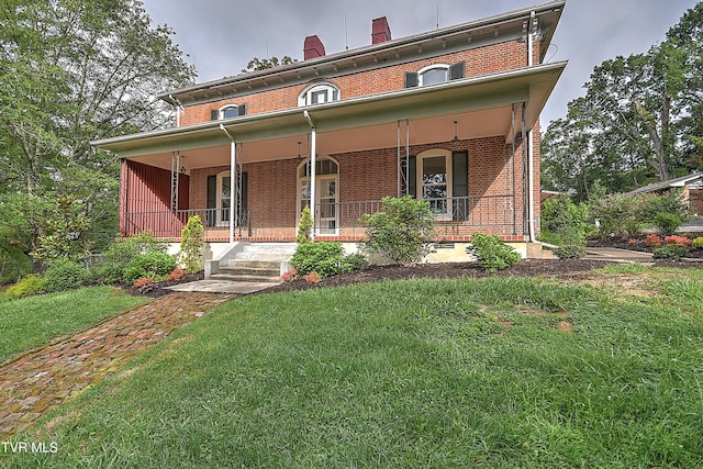 2061 King College Rd, Bristol, TN 37620 - view of front of property with brick siding, covered porch, a front lawn, and a chimney