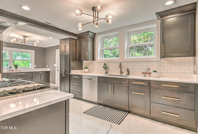 2061 King College Rd, Bristol, TN 37620 - kitchen with appliances with stainless steel finishes, a chandelier, light marble finish flooring, tasteful backsplash, and light stone countertops