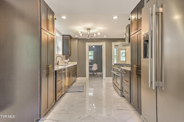2061 King College Rd, Bristol, TN 37620 - kitchen featuring appliances with stainless steel finishes, light marble finish flooring, range hood, recessed lighting, and light countertops
