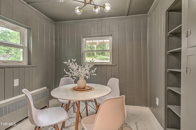 2061 King College Rd, Bristol, TN 37620 - dining space featuring radiator, plenty of natural light, wood walls, light marble finish flooring, and a chandelier