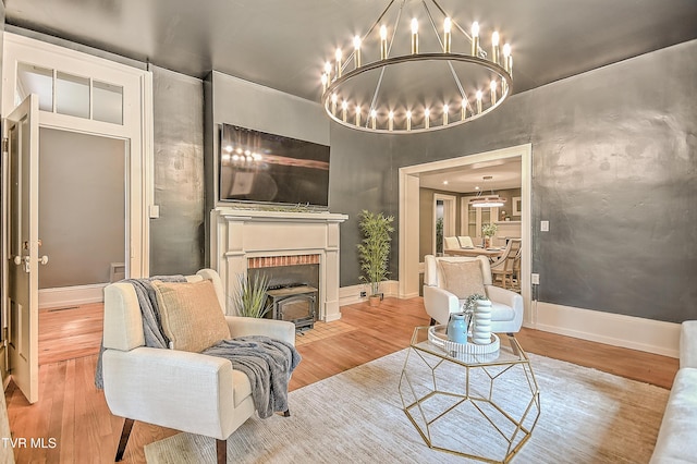2061 King College Rd, Bristol, TN 37620 - living room featuring wood finished floors, a chandelier, and a fireplace with flush hearth