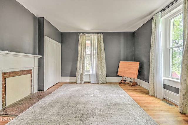 2061 King College Rd, Bristol, TN 37620 - unfurnished living room featuring healthy amount of natural light, wood finished floors, and a fireplace