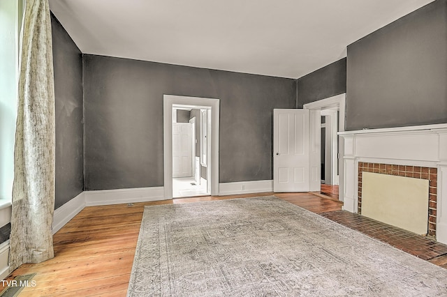 2061 King College Rd, Bristol, TN 37620 - unfurnished living room featuring wood finished floors and a tiled fireplace