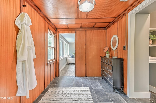 2061 King College Rd, Bristol, TN 37620 - corridor featuring wood ceiling, wooden walls, and dark stone finish floors