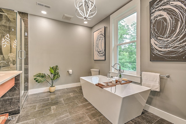 2061 King College Rd, Bristol, TN 37620 - full bathroom featuring healthy amount of natural light, a freestanding bath, a chandelier, a shower stall, and recessed lighting